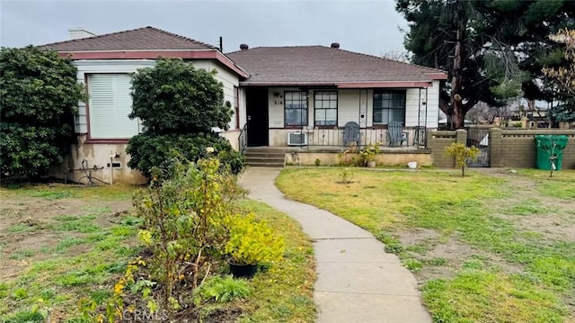 bungalow-style house featuring a porch and a front yard