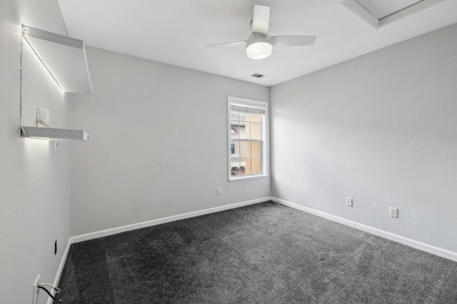 carpeted spare room featuring ceiling fan