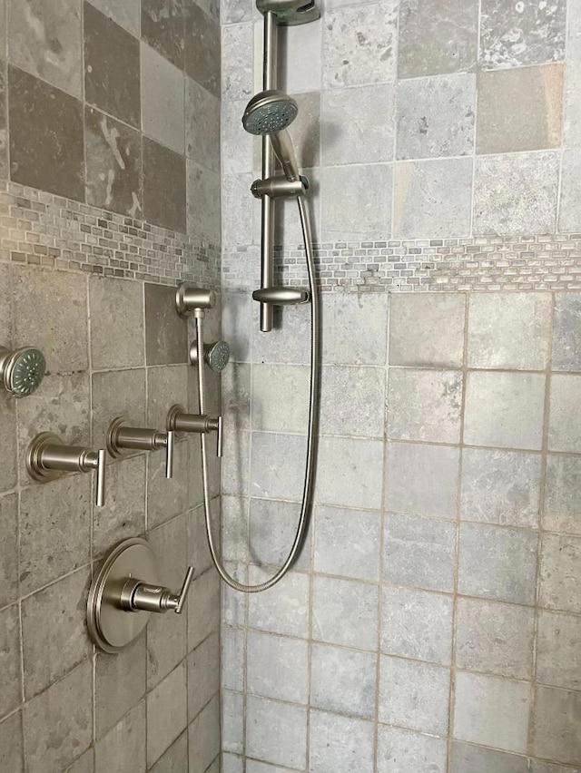 interior details featuring tiled shower