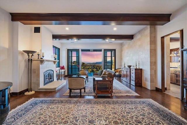 sitting room featuring beam ceiling and dark hardwood / wood-style floors