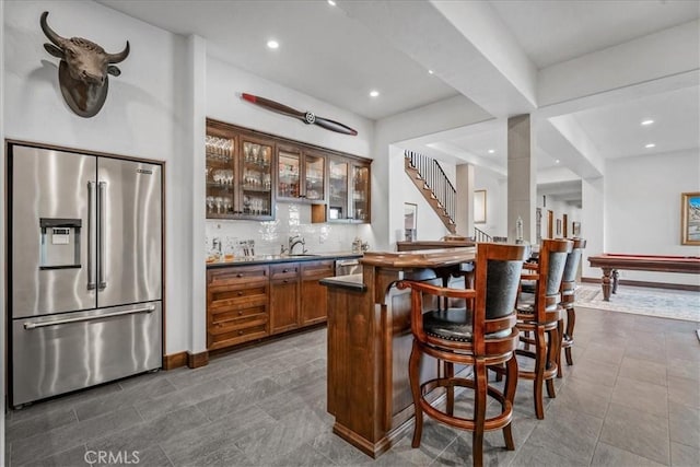 bar with decorative backsplash, pool table, and appliances with stainless steel finishes