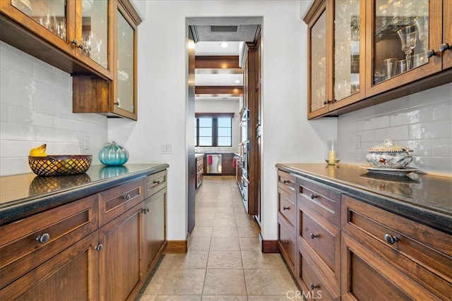 kitchen with backsplash and light tile patterned floors