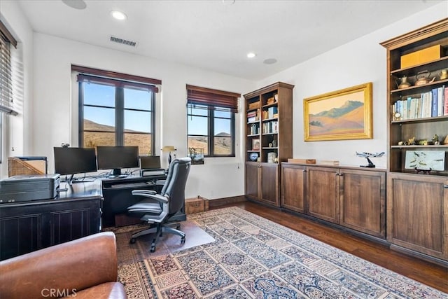 office with dark hardwood / wood-style flooring