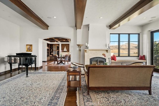 living room featuring beam ceiling and dark wood-type flooring