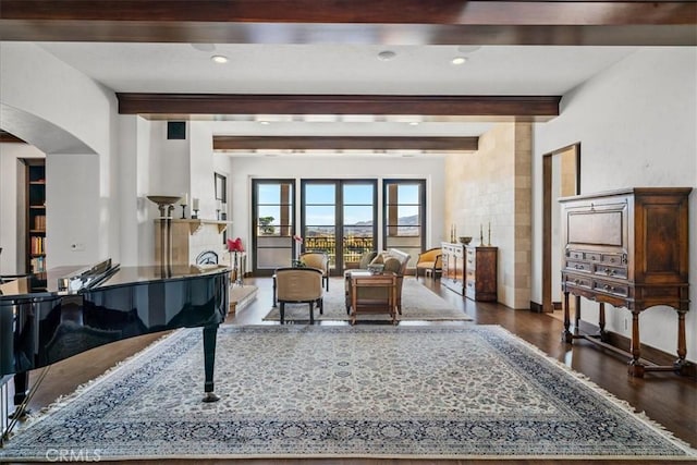 interior space with beam ceiling and dark hardwood / wood-style floors