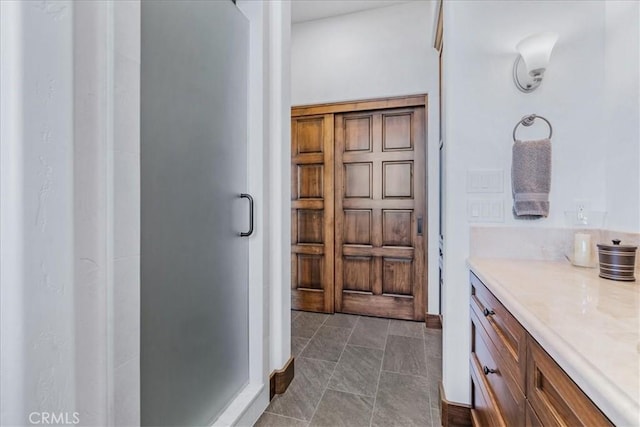 bathroom with vanity and a shower with shower door