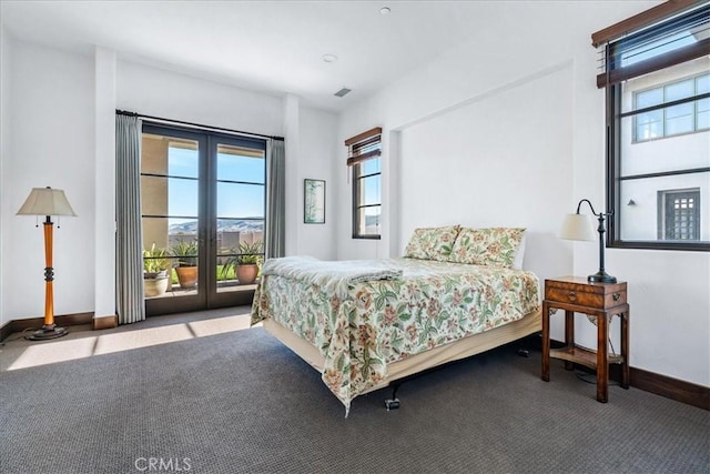 carpeted bedroom featuring access to outside and multiple windows