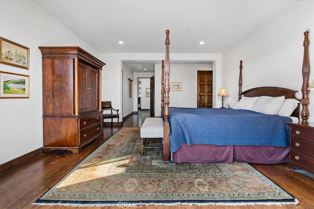 bedroom with dark hardwood / wood-style floors