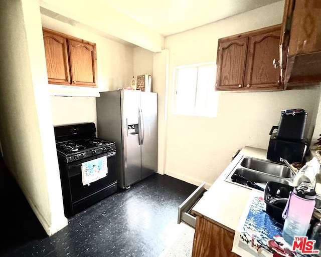 kitchen with stainless steel fridge, black gas range, and sink