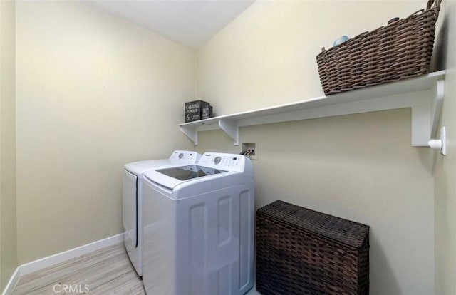 laundry room featuring washer and dryer and light hardwood / wood-style floors