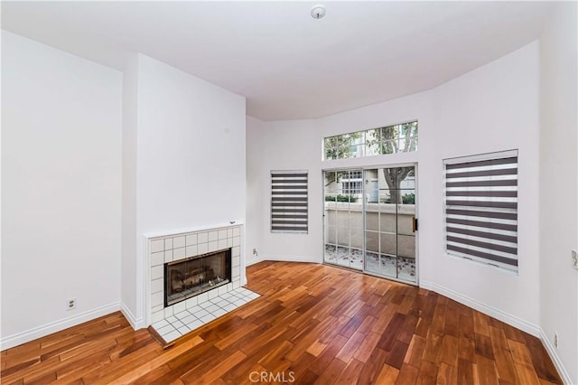 unfurnished living room with hardwood / wood-style flooring and a fireplace