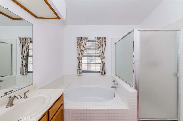 bathroom featuring vanity and shower with separate bathtub