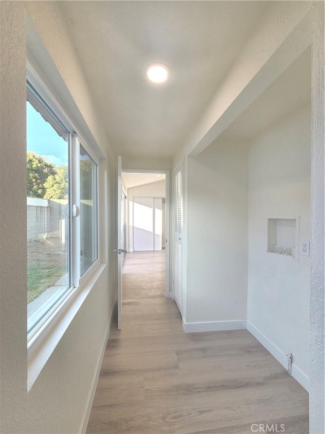 hall with light wood-type flooring