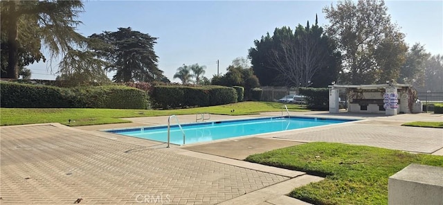 view of pool with a patio area, a yard, and a pergola