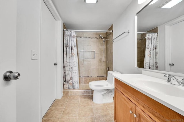 bathroom with toilet, vanity, tile patterned floors, and walk in shower