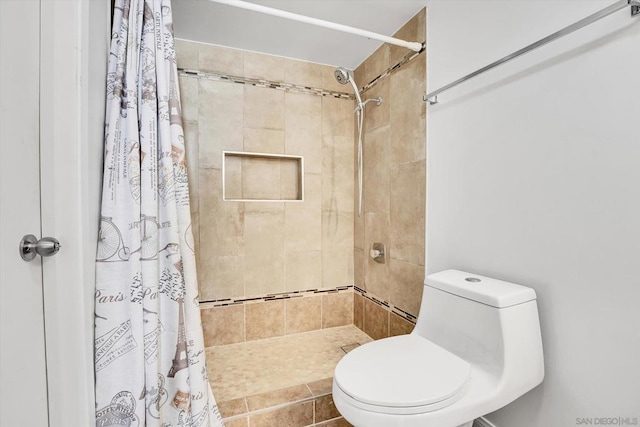 bathroom featuring curtained shower and toilet