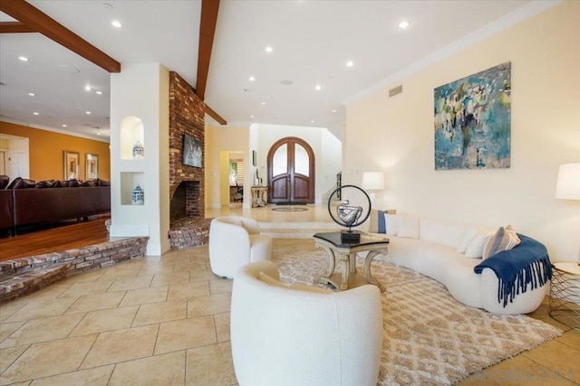 living room featuring beam ceiling, ornamental molding, and a brick fireplace