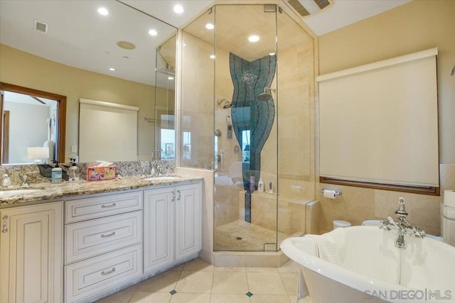 bathroom featuring tile patterned flooring, shower with separate bathtub, and vanity