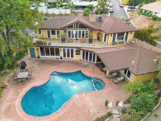 exterior space with a fenced in pool and a patio