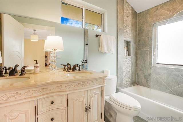 full bathroom featuring vanity, toilet, and plenty of natural light