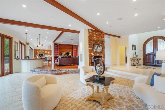 living room featuring beam ceiling and a fireplace