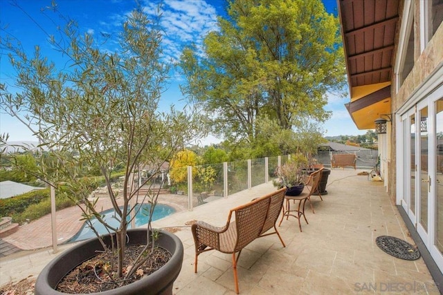 view of patio with a fenced in pool