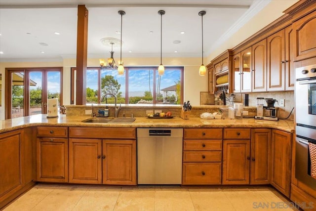 kitchen with a chandelier, stainless steel appliances, plenty of natural light, and sink