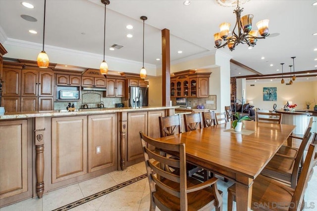 dining room with light tile patterned floors, crown molding, and a chandelier