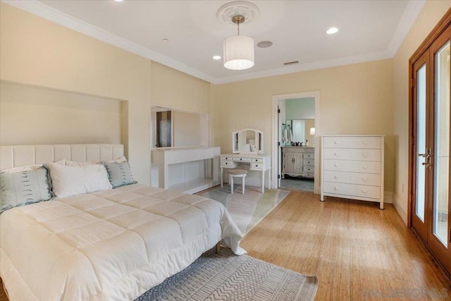 bedroom with wood-type flooring, connected bathroom, and crown molding