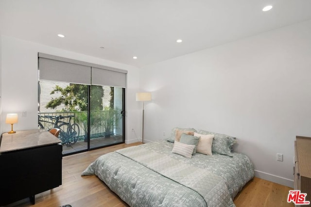 bedroom featuring access to outside and light wood-type flooring