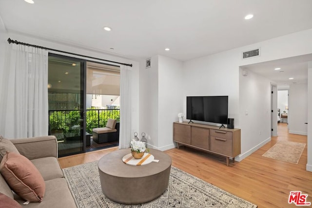 living room with light hardwood / wood-style flooring