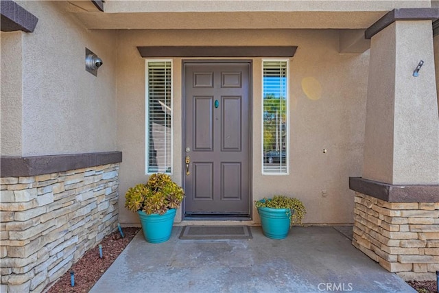 doorway to property with stucco siding