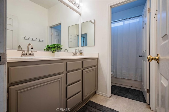 full bathroom with a shower with shower curtain, double vanity, toilet, and a sink