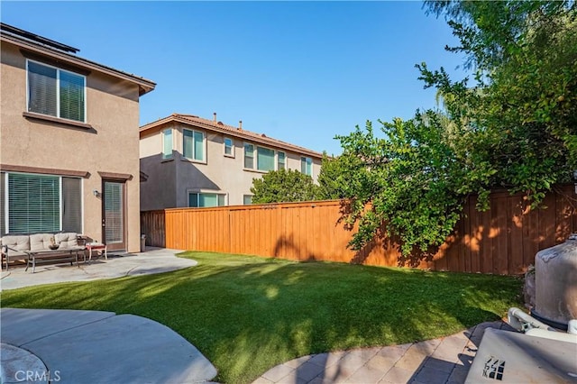 view of yard with a patio area, an outdoor living space, and a fenced backyard