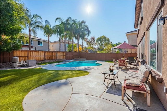 view of swimming pool featuring a patio, a yard, a fenced backyard, and a fenced in pool