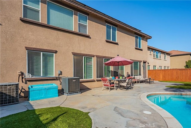 back of house with a patio, fence, and stucco siding