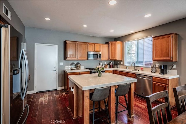 kitchen with tile countertops, visible vents, appliances with stainless steel finishes, and dark wood finished floors