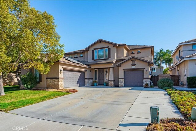 view of front of home featuring a garage and a front lawn