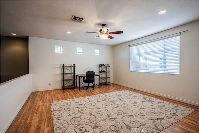 office featuring recessed lighting, visible vents, baseboards, and wood finished floors