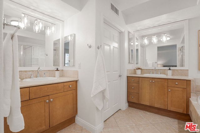 bathroom featuring tile patterned flooring and vanity