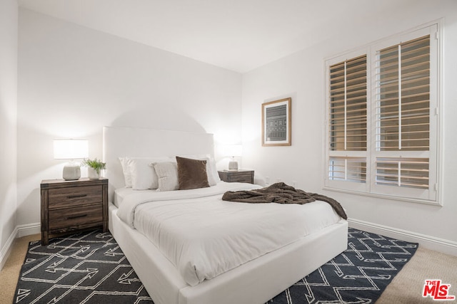 bedroom featuring dark carpet