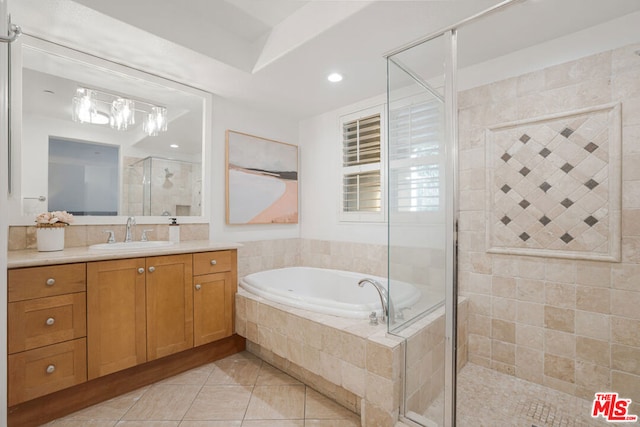 bathroom with tile patterned flooring, vanity, and shower with separate bathtub