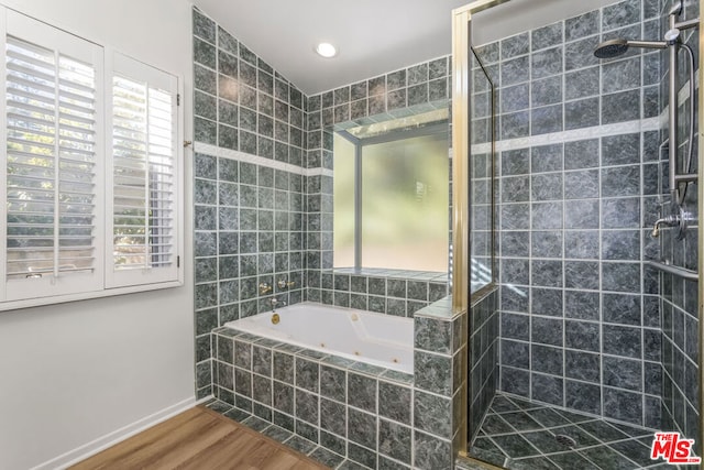 bathroom featuring hardwood / wood-style floors and plus walk in shower