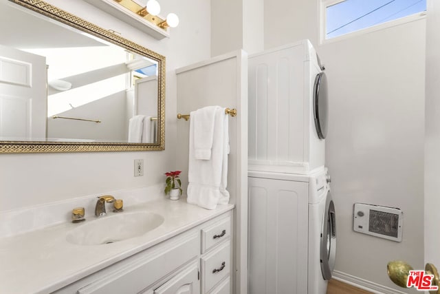 bathroom with vanity and stacked washer and dryer