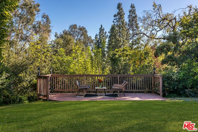 wooden terrace with a yard