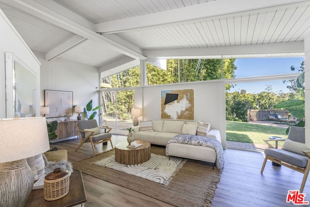 sunroom with lofted ceiling with beams