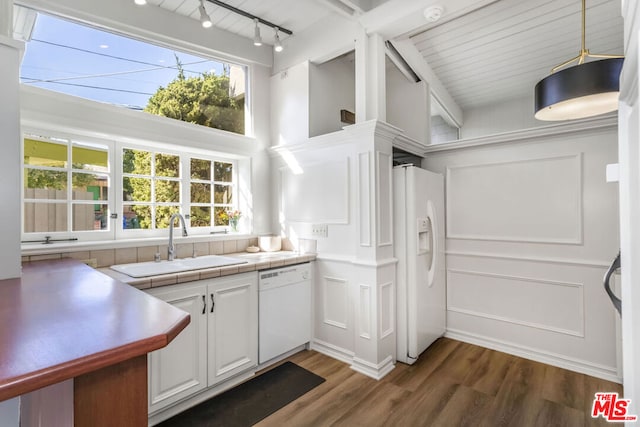 kitchen with white appliances, dark wood-type flooring, sink, white cabinetry, and tile counters