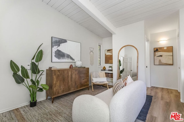 sitting room with hardwood / wood-style floors, vaulted ceiling with beams, and wooden ceiling