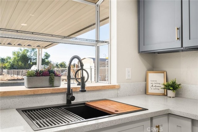 interior details featuring gray cabinetry and sink