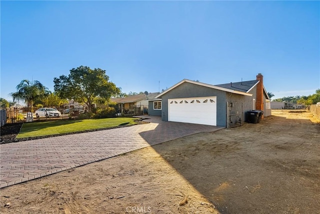 view of front of house with a front yard and a garage